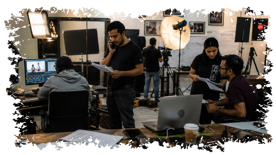 Urja AI Media creative team collaborating around monitors in the studio